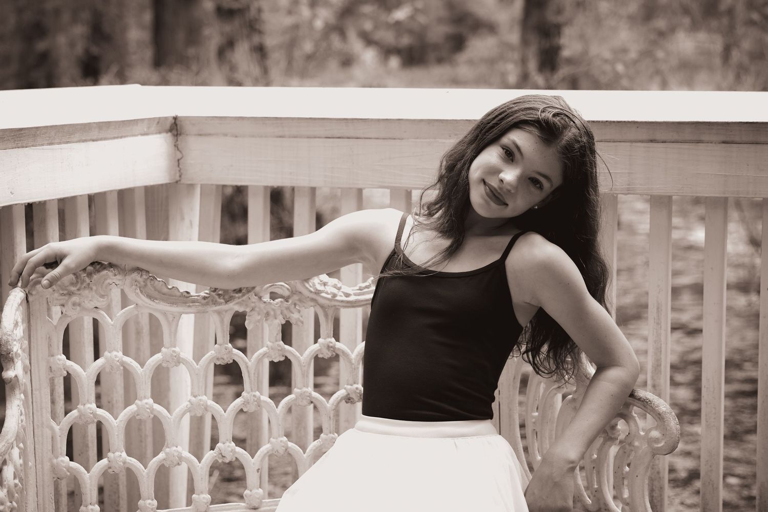 Artistic portrait sequence showing relaxed poses on a decorative porch railing.