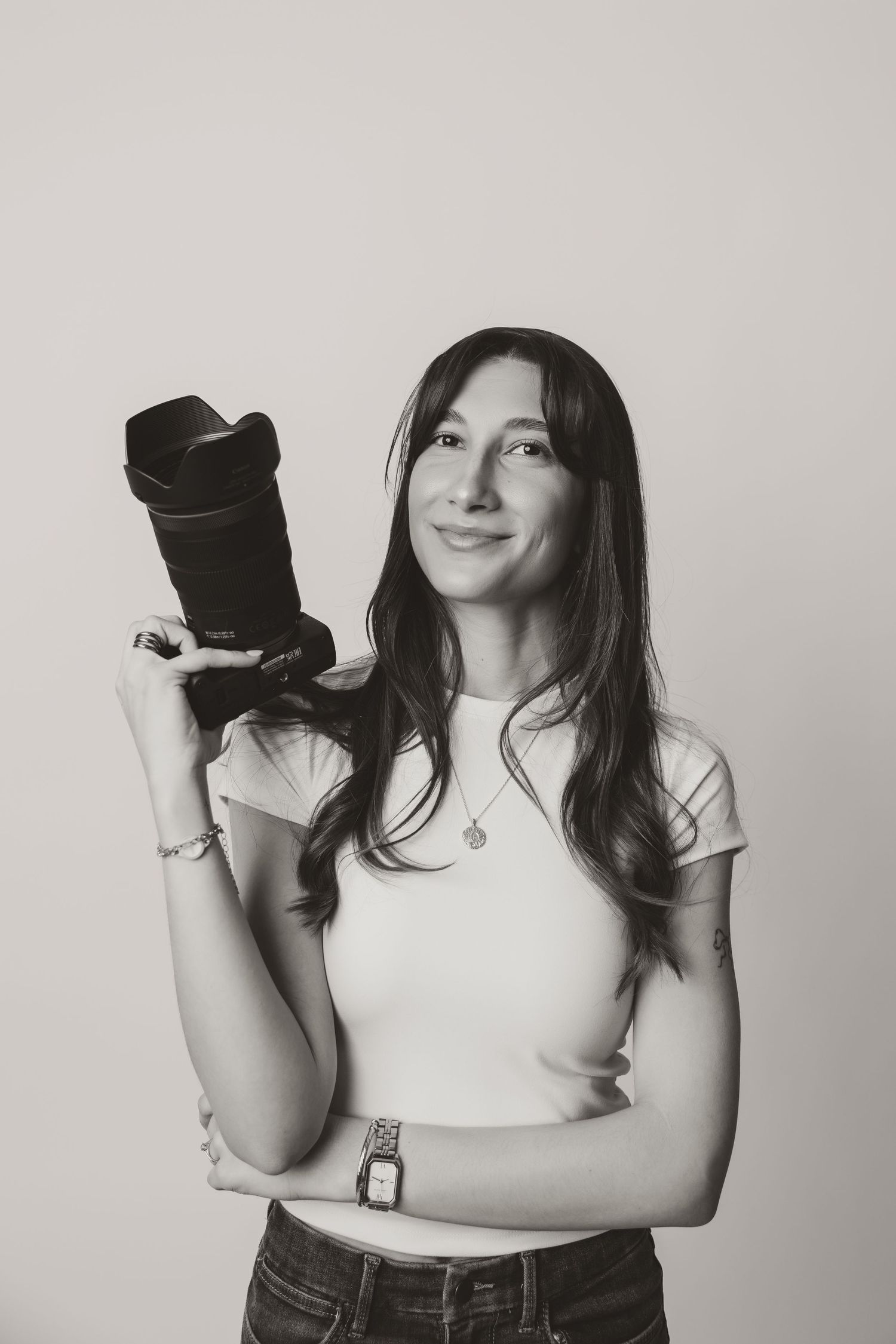 Black and white studio portraits with camera equipment against neutral background.