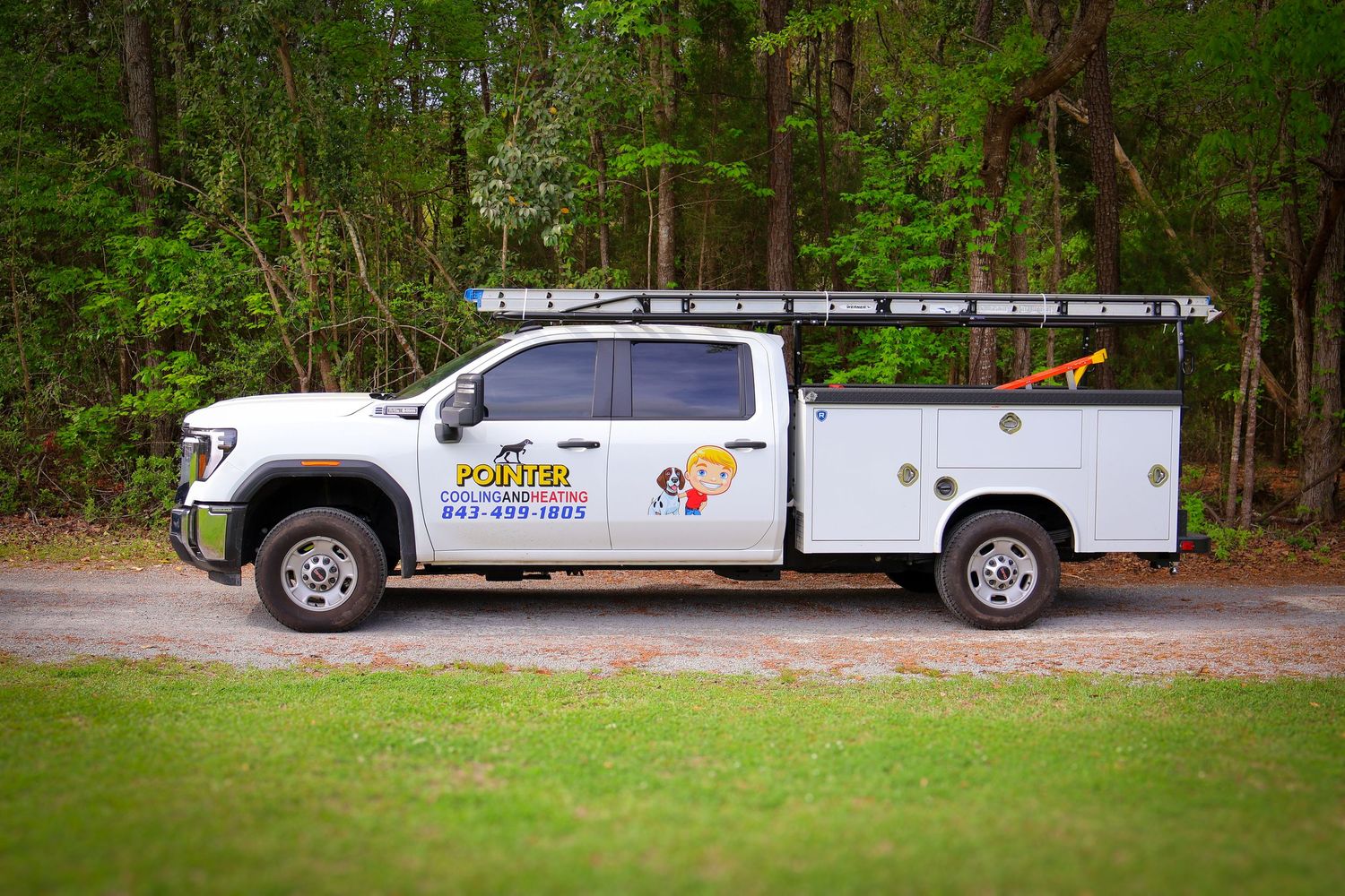 Fleet of white service vans parked in a wooded area.