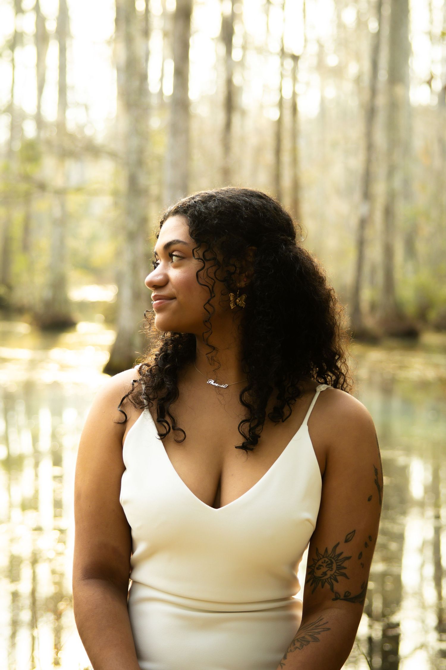 Portrait session in dreamy swamp setting with Spanish moss and filtered sunlight.