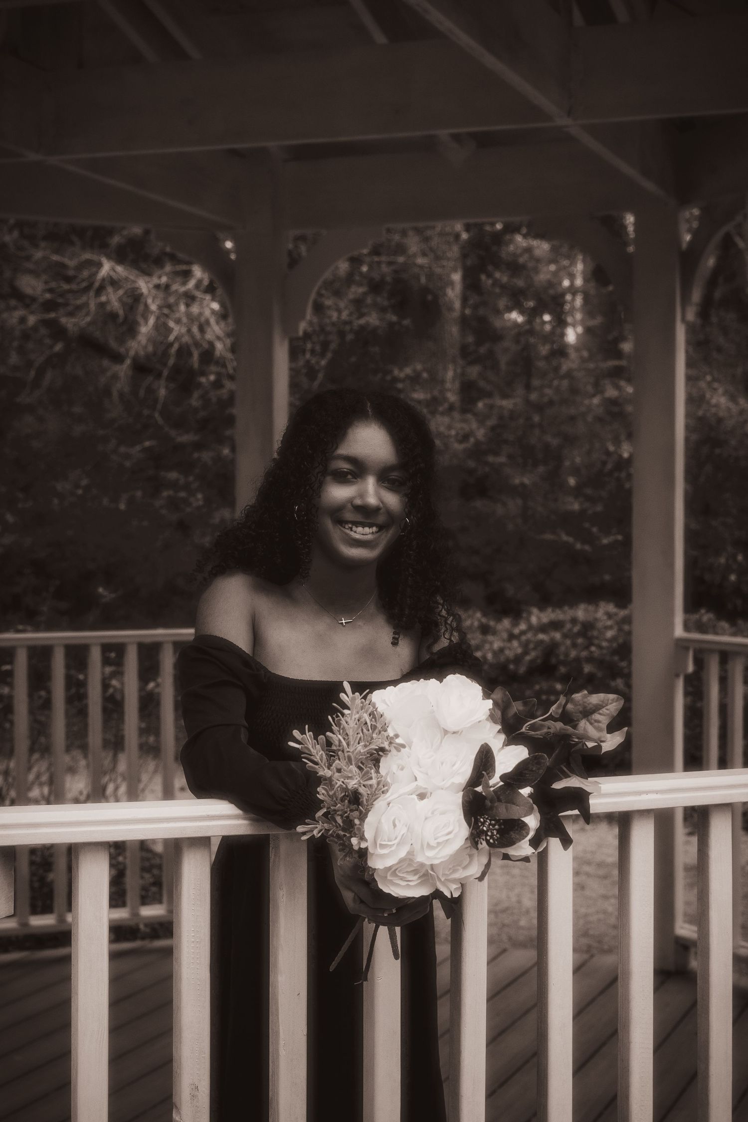 Artistic black and white portraits taken on a white porch railing.