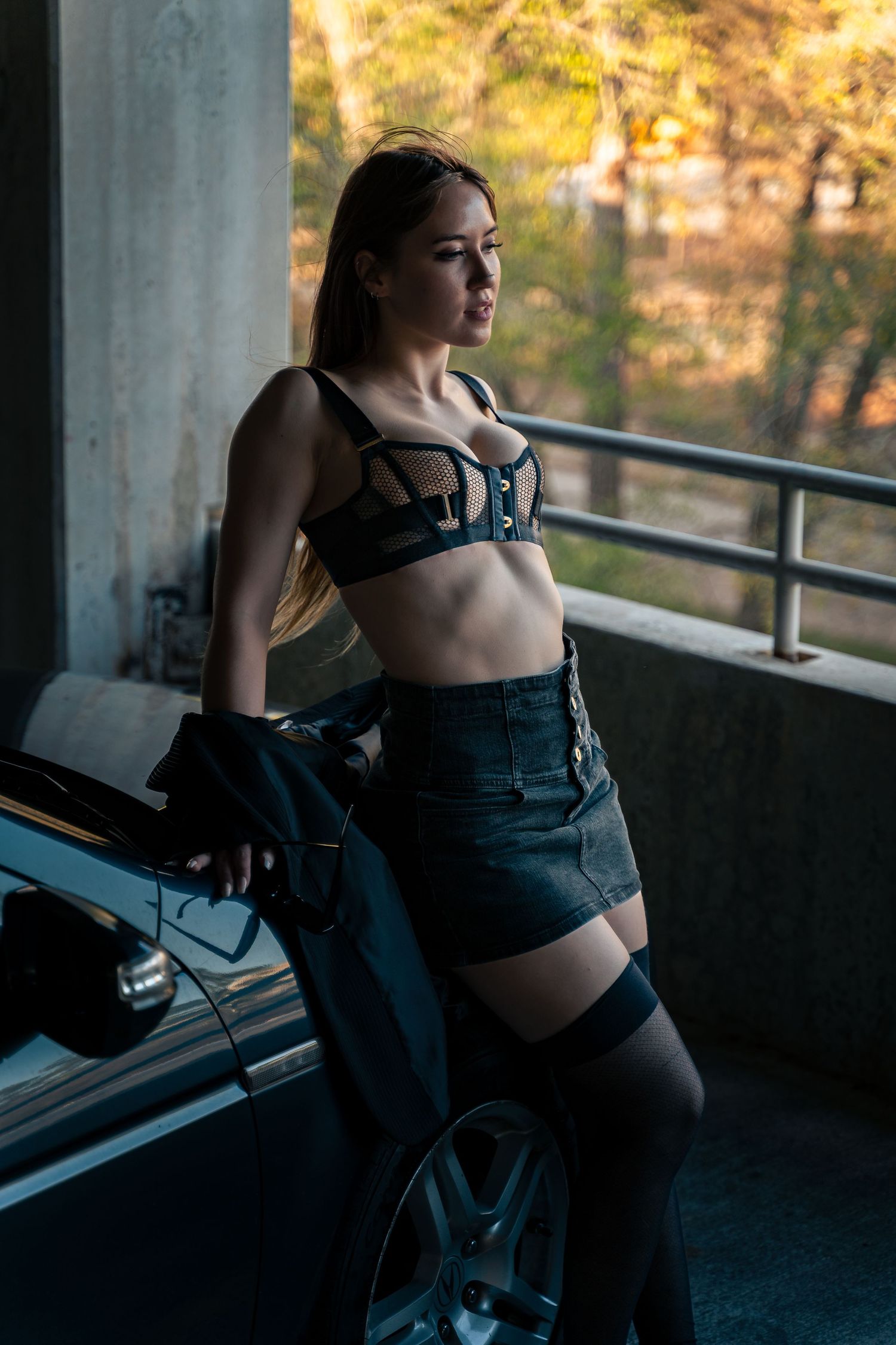 Moody artistic photo series showing silhouette against sunset light in urban parking structure setting.