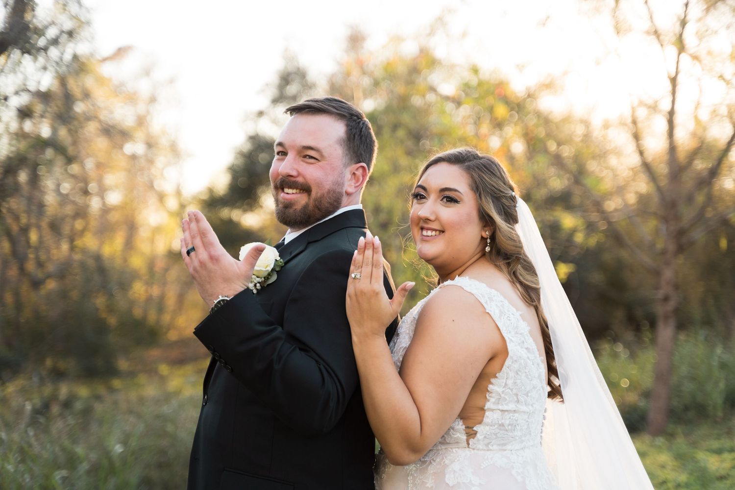 Joyful wedding party laughs and celebrates during outdoor photo session.