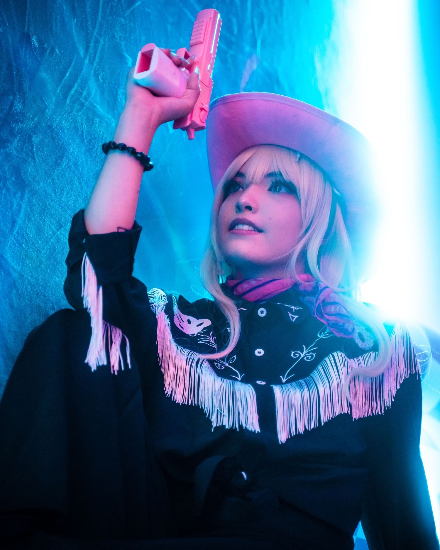 Cyberpunk style portrait with neon blue lighting and futuristic fashion elements.