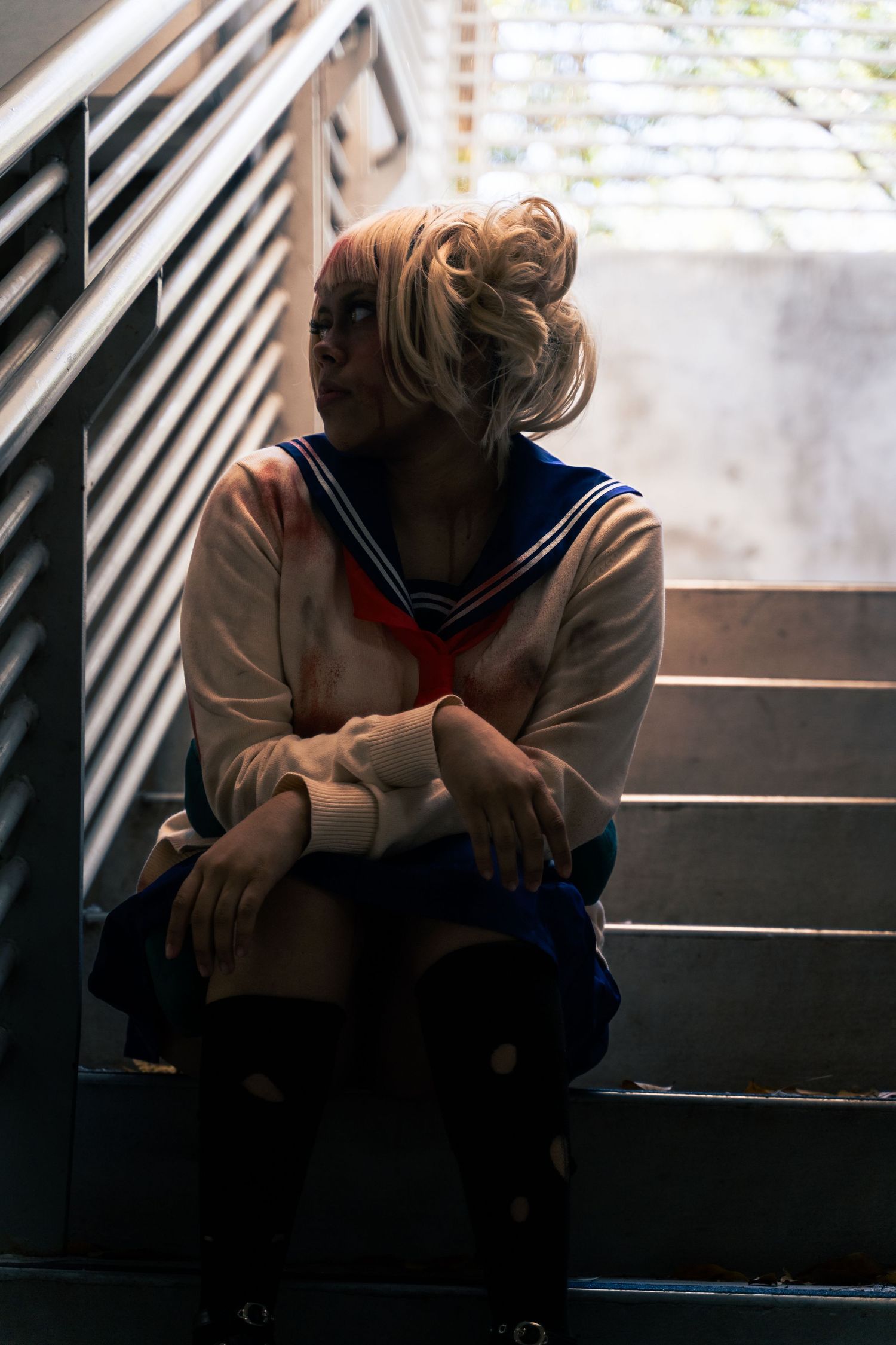 A series of dark moody photos showing a person in a light colored hoodie sitting alone in shadows by a window.