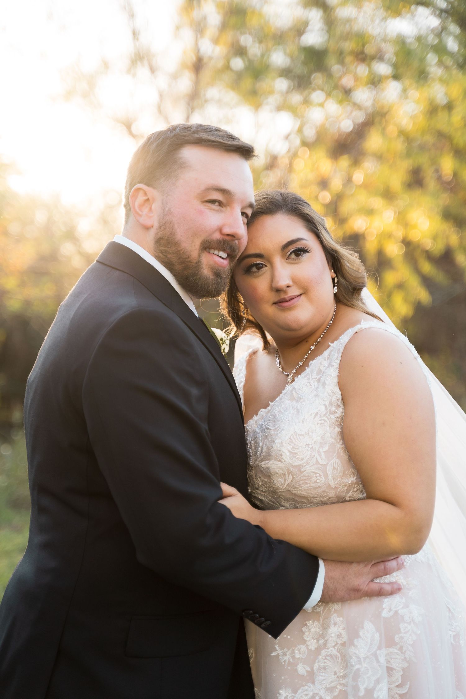 Romantic wedding couple shares tender moments during sunset portrait session.