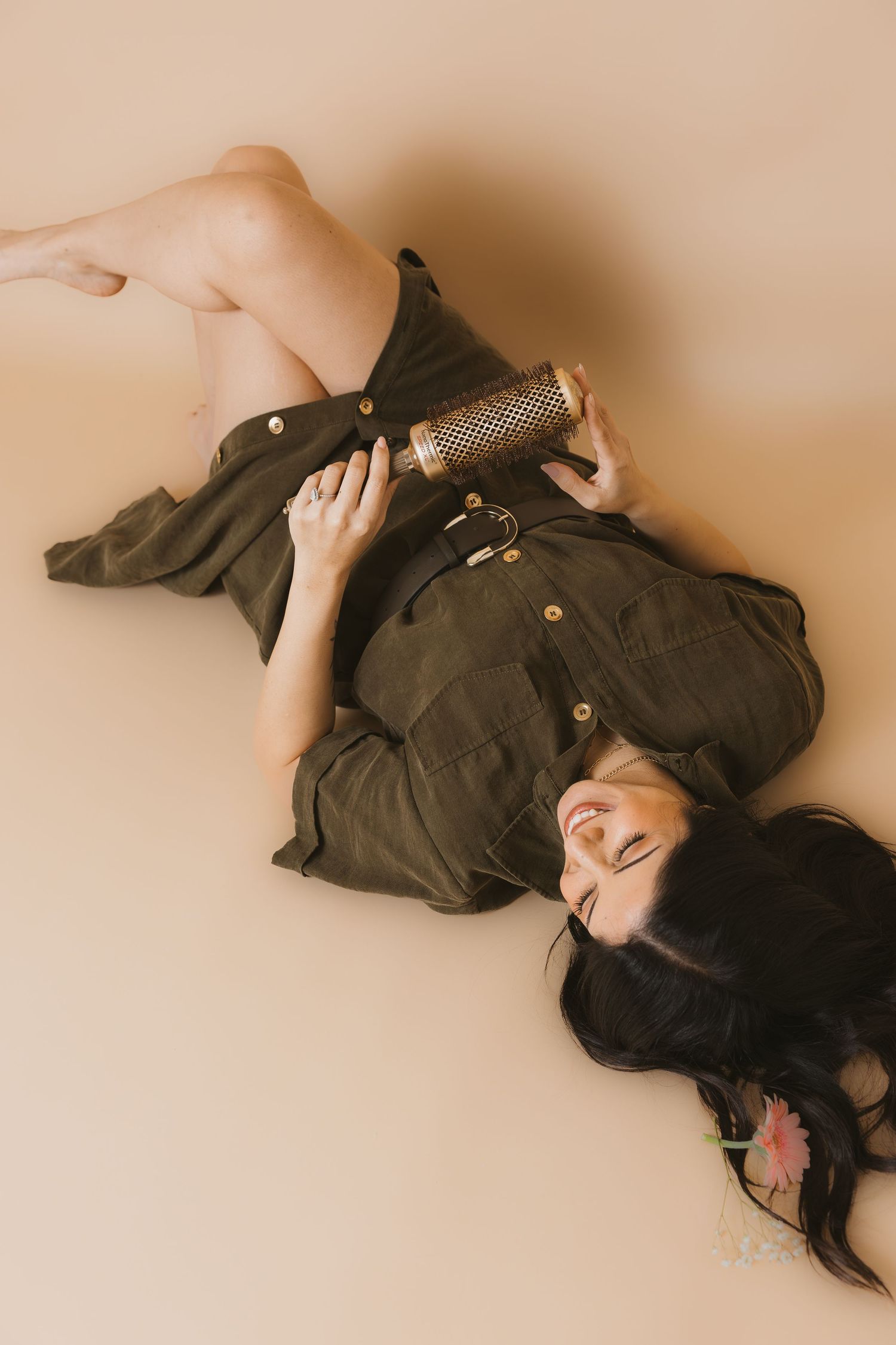 Artistic photo series of a person lying down in black clothing against a beige background.