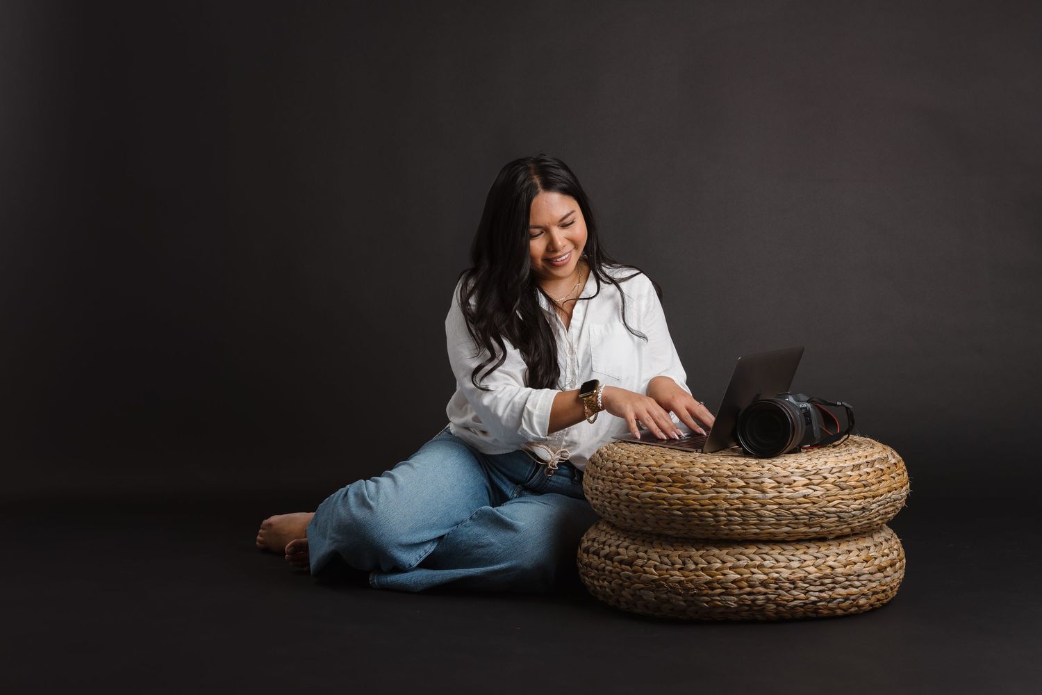 Lifestyle photography with woven basket furniture against dark dramatic background.