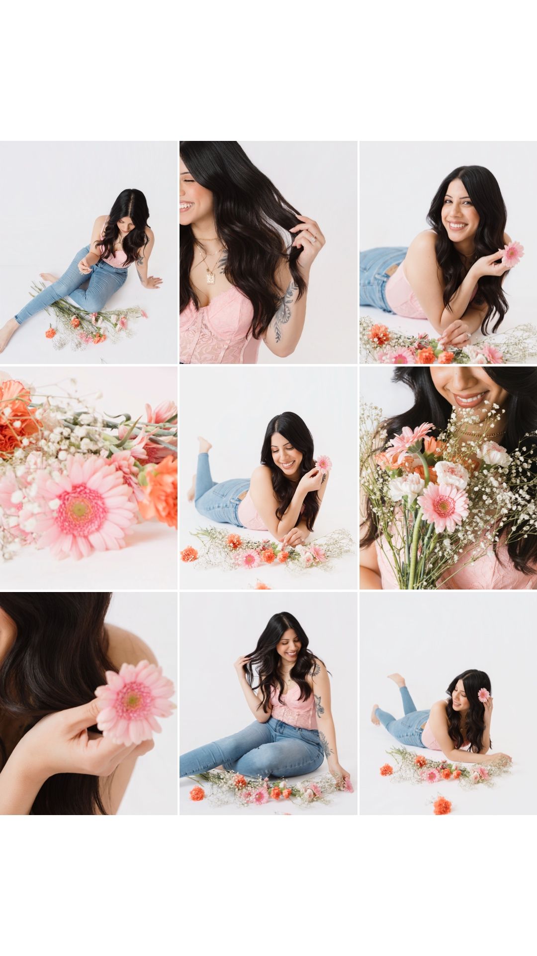A young woman in a pink top and jeans poses among colorful spring flowers in a bright white studio setting.