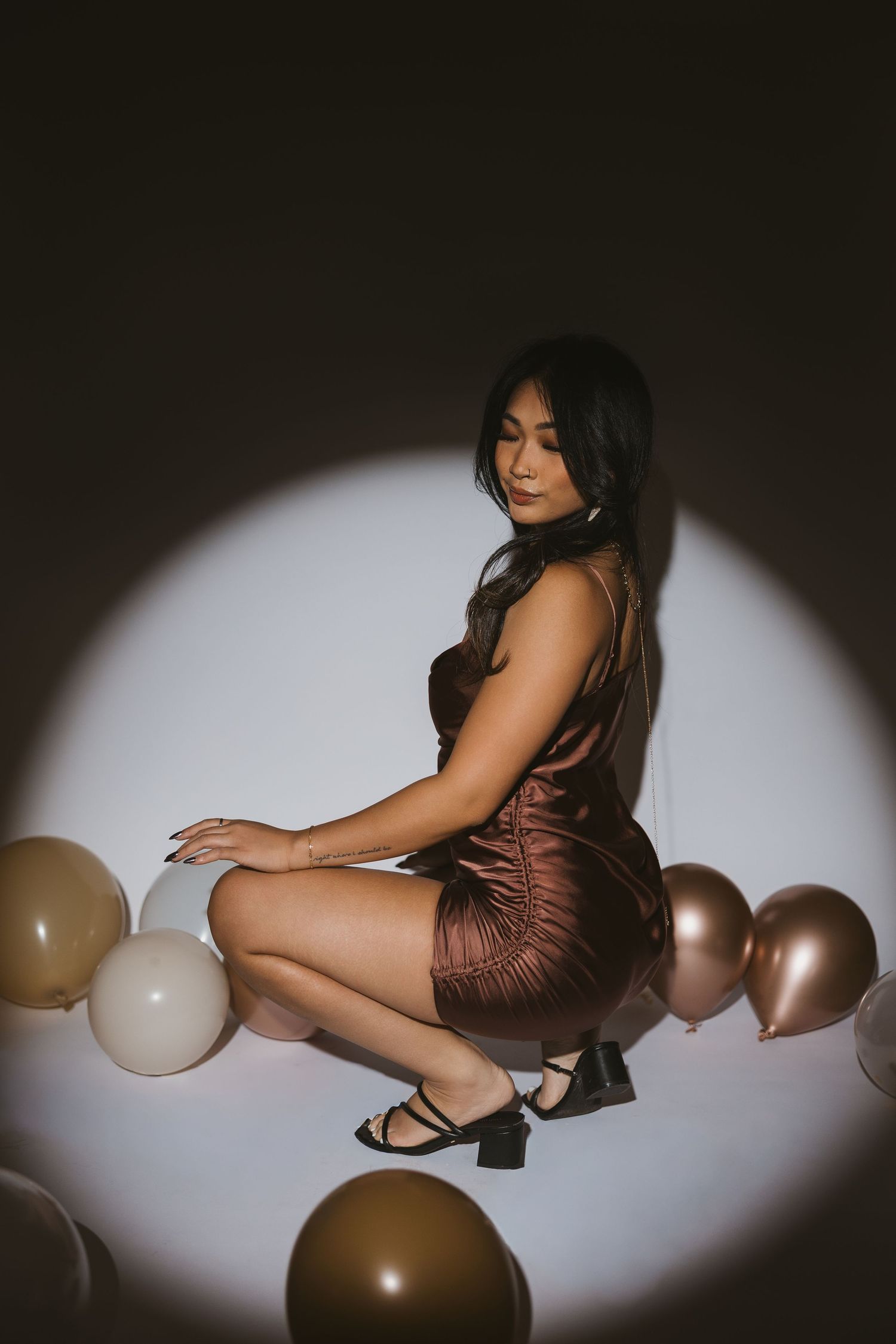 Artistic photo series with brown and gold balloons in dramatic lighting.