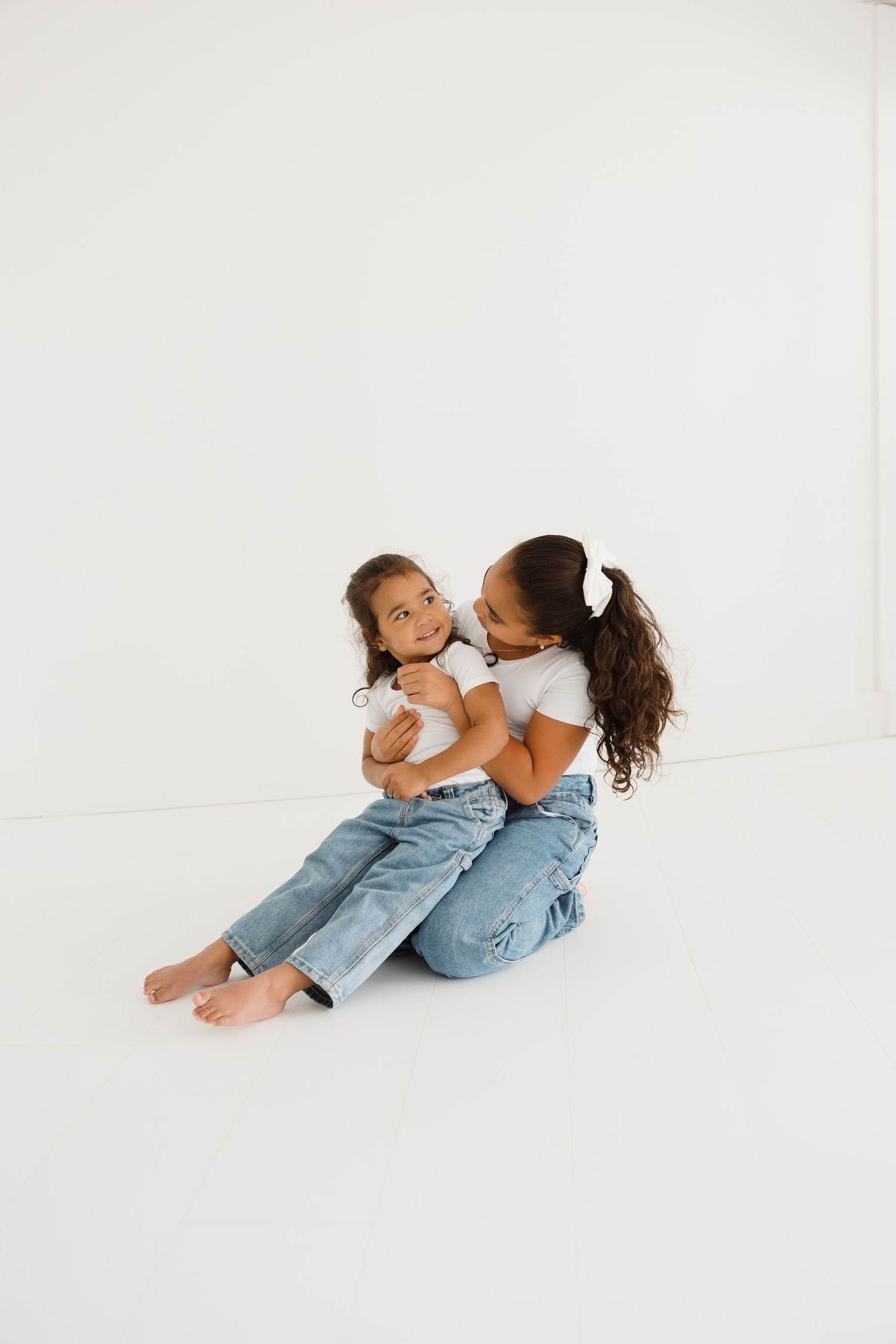 Intimate family moments captured against a clean white backdrop.