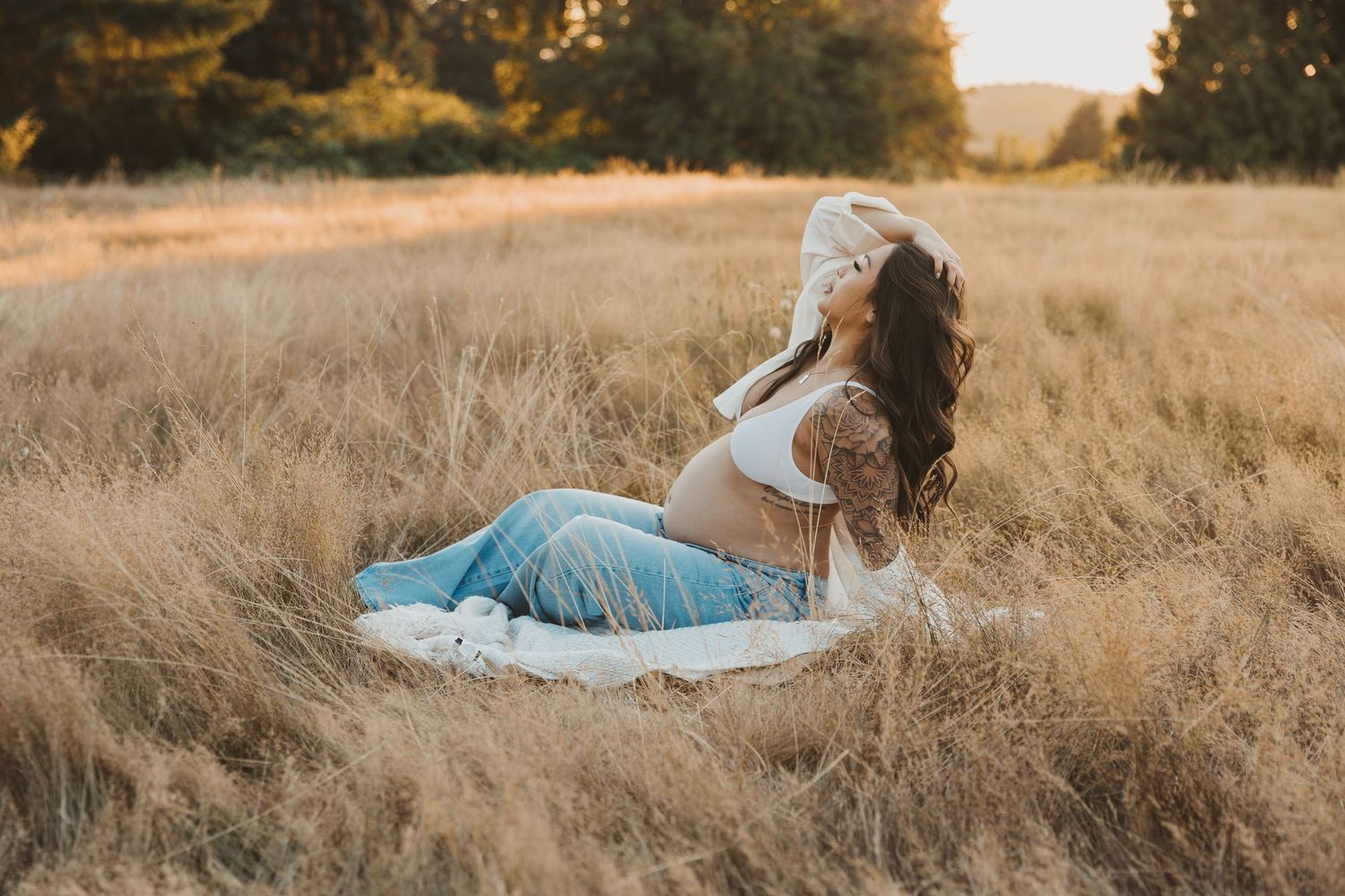 Multiple shots of someone reclining in a golden grass field at sunset.