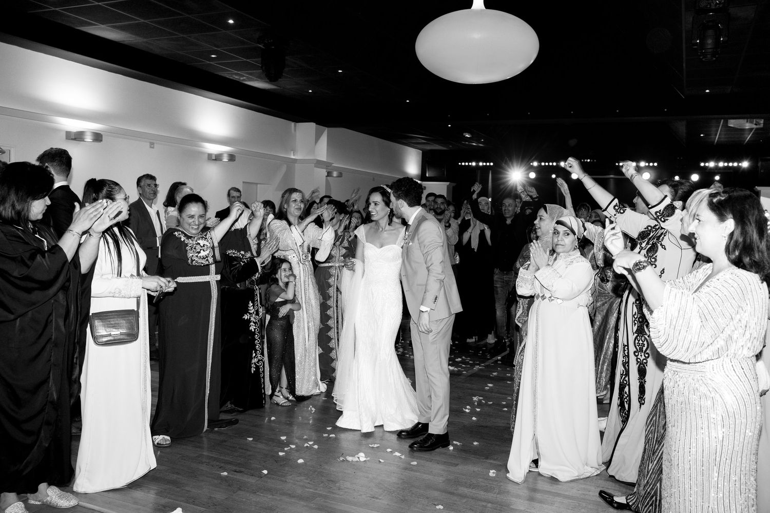 Black and white wedding reception photos showing guests dancing and celebrating on the dance floor.