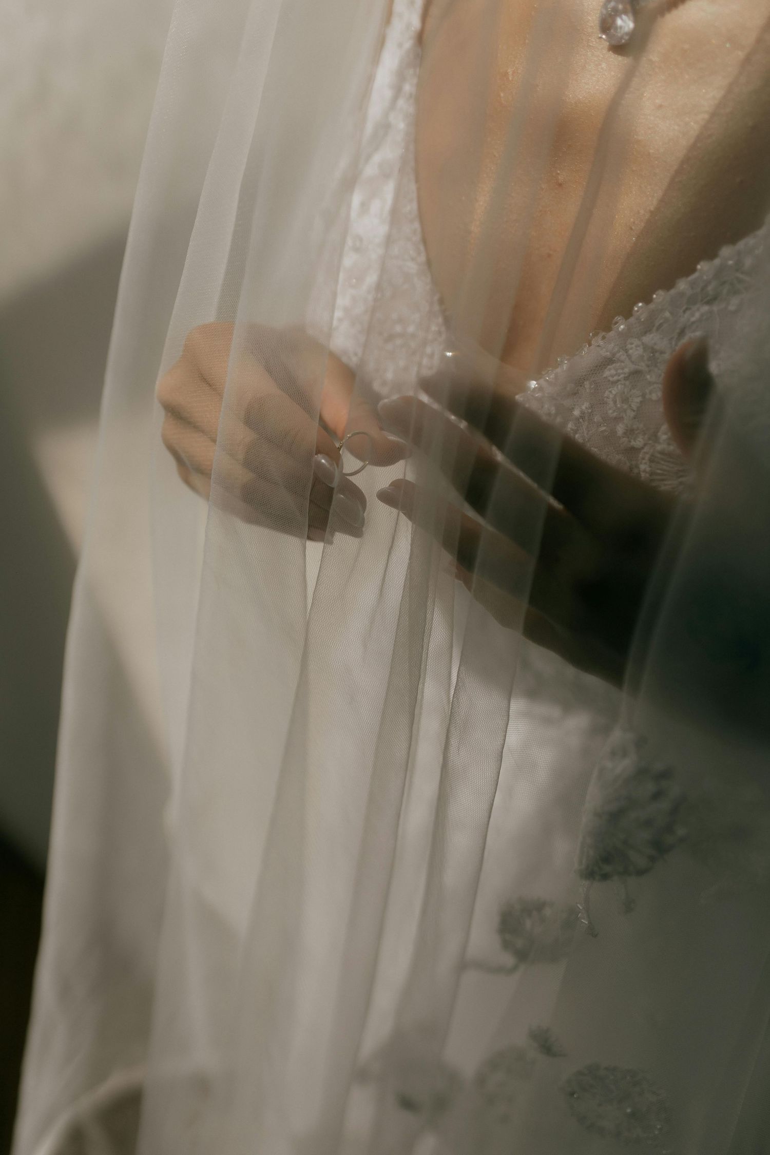 Close-up details of white lace wedding dress fabric.
