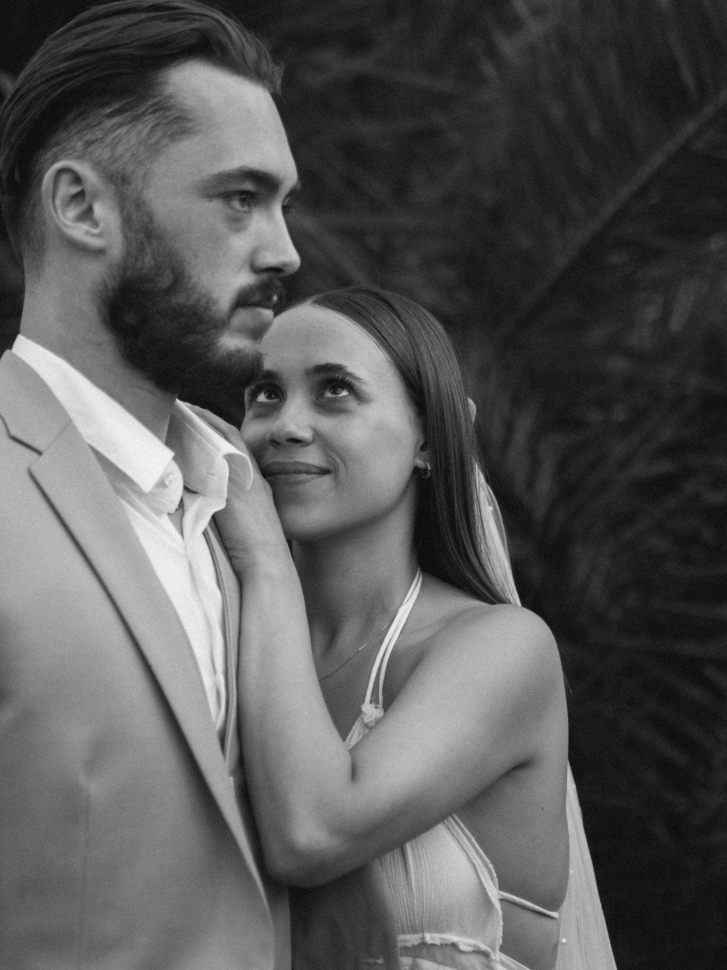 A series of intimate black and white wedding portraits capturing tender moments between newlyweds.