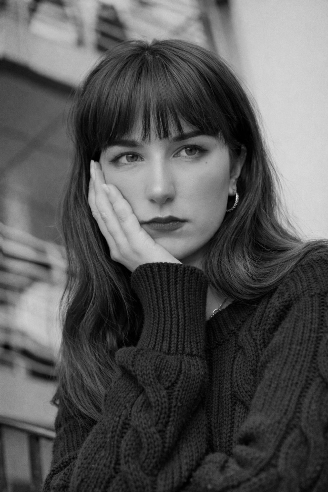 Moody black and white fashion portrait featuring a person in a turtleneck sweater.