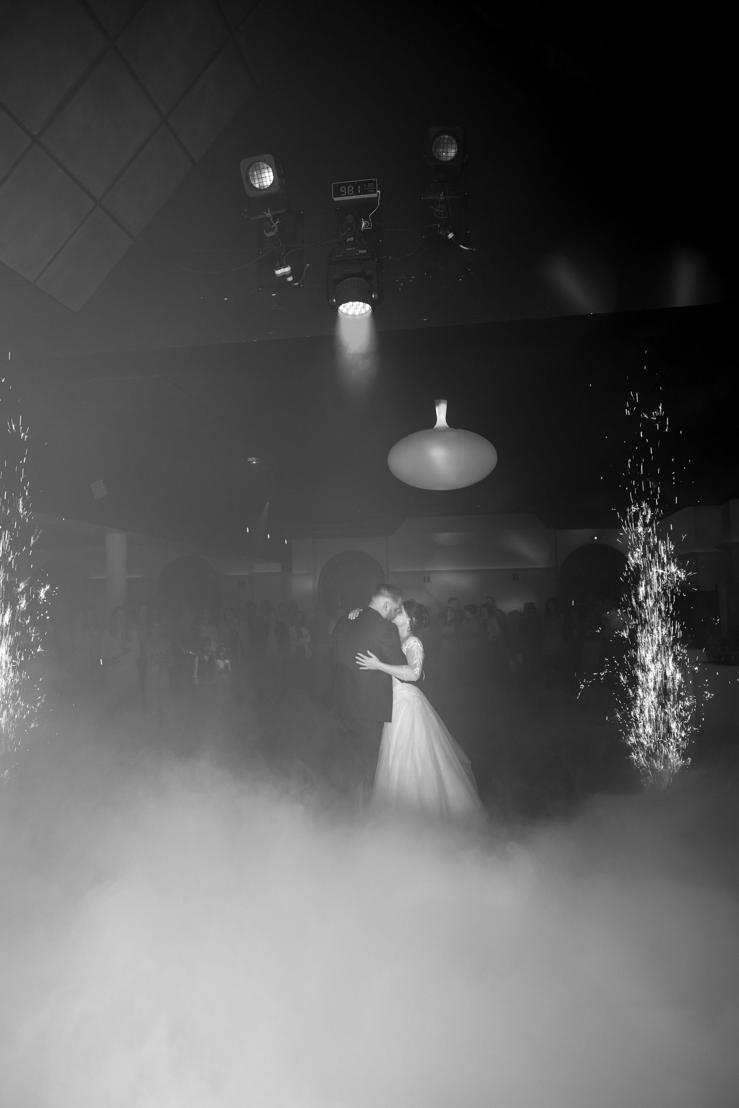 A dreamy black and white first dance scene with fog effects and dramatic lighting.