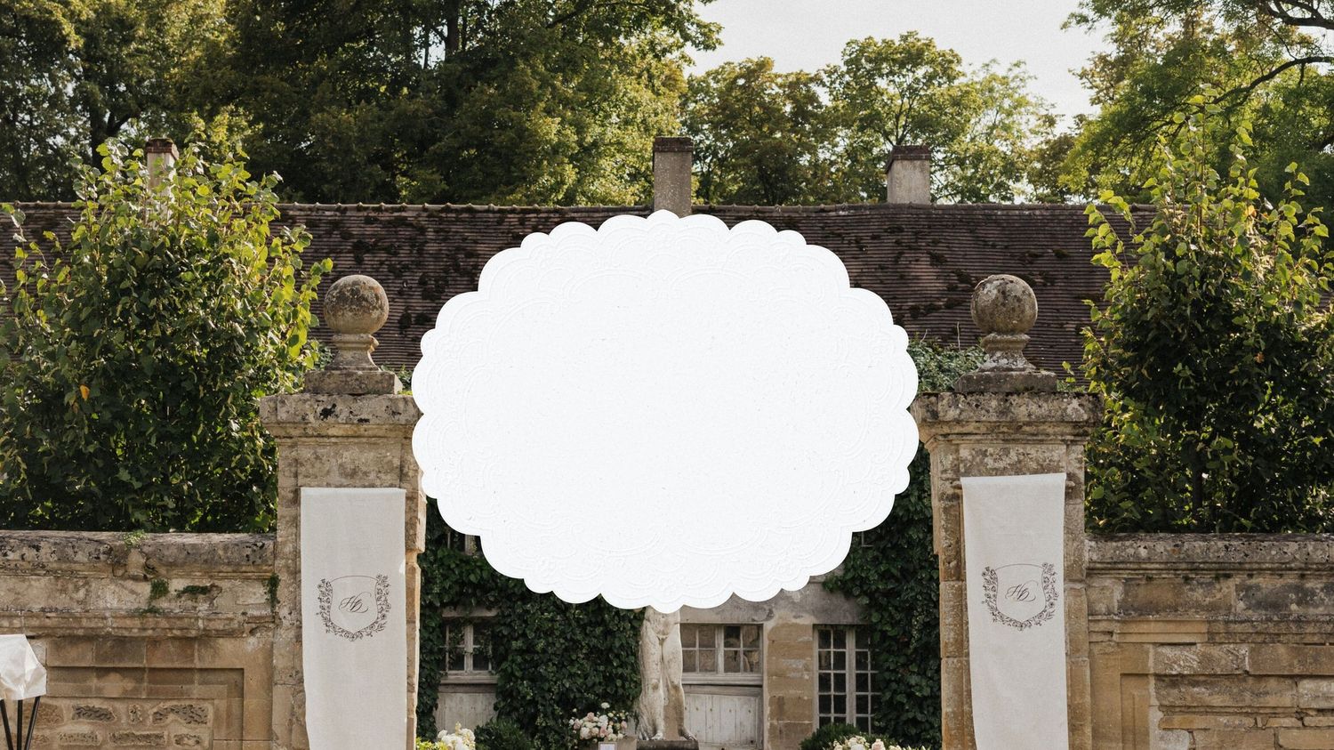 A decorative stone archway entrance with greenery and white space for text.