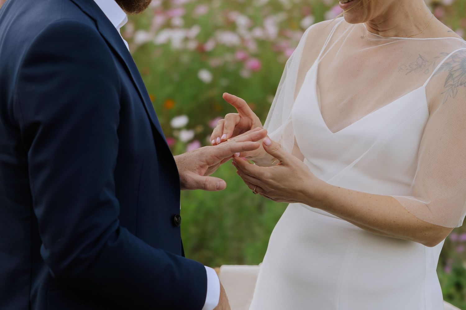 Close-up shots of hands during wedding ceremony exchange.