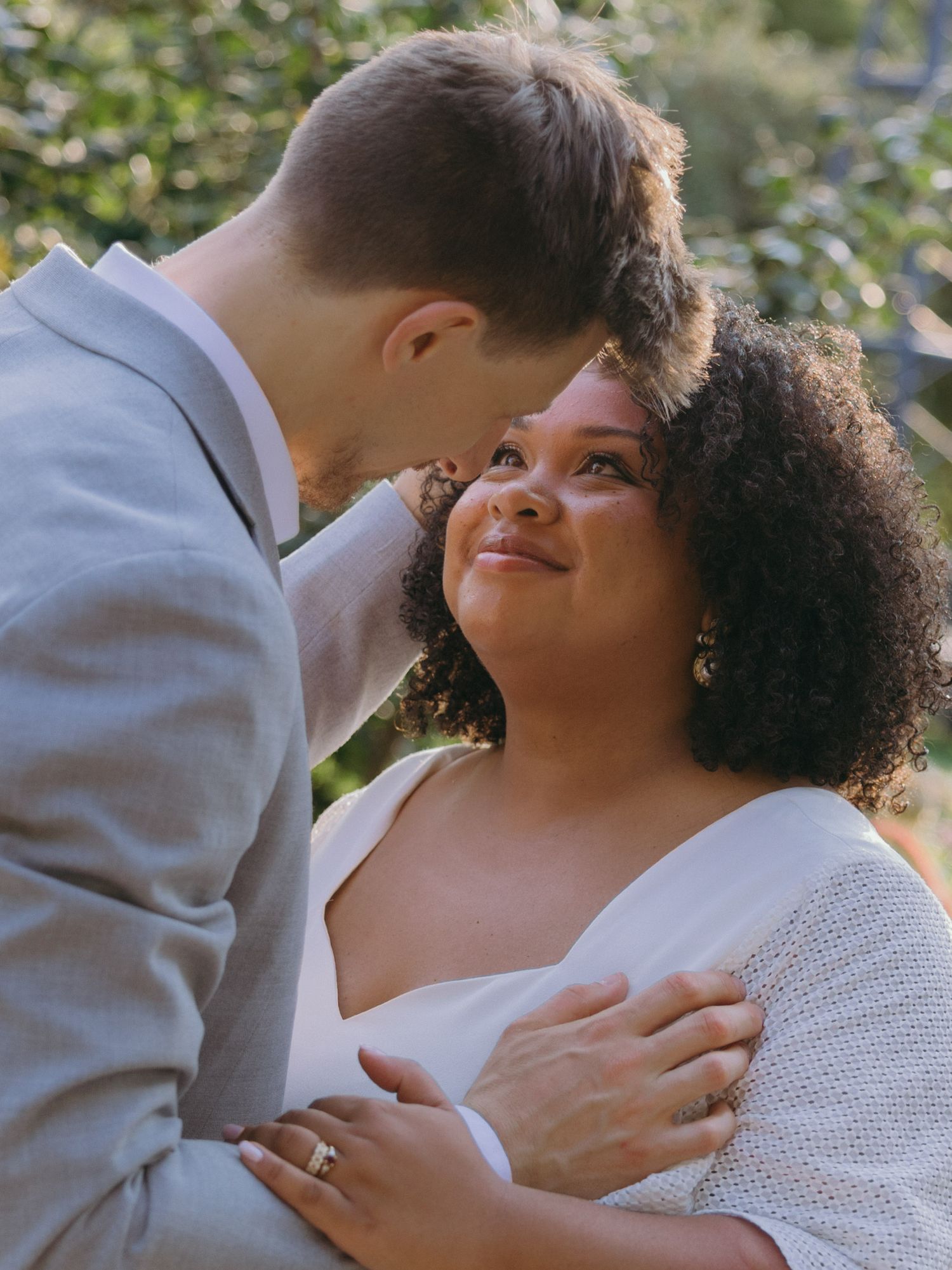A tender romantic moment between a couple in coordinated formal wear.