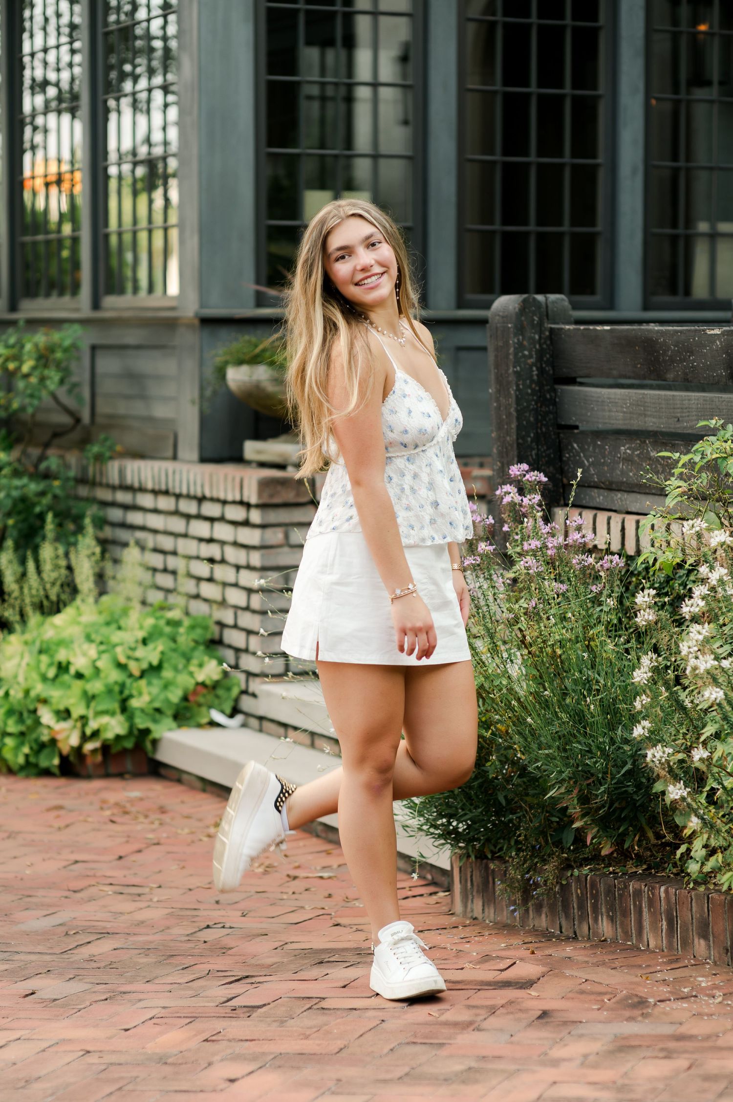 Four sequential lifestyle photos of a spring garden scene with brick patio and lush flowering plants.