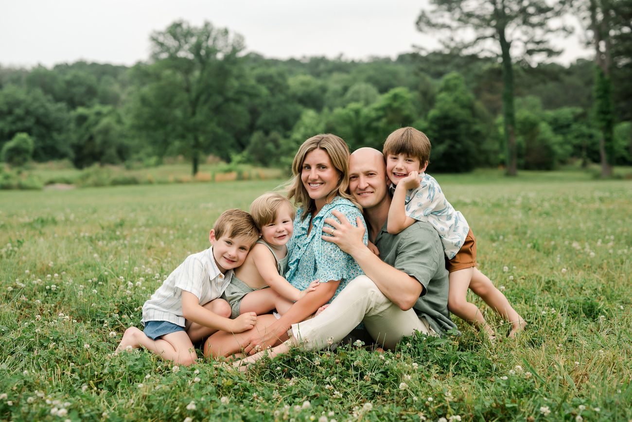 family sitting together in open field alabama birmingham