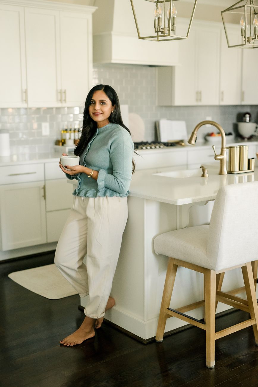Casual lifestyle scenes in modern kitchen with white cabinets and bar stools.