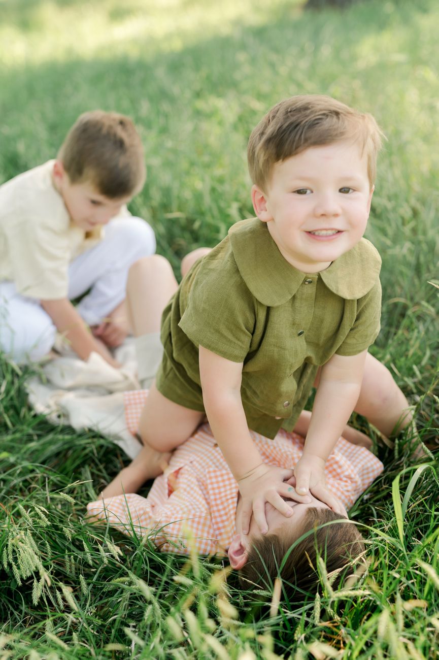 Series of photos showing playtime in tall grass on a sunny day.