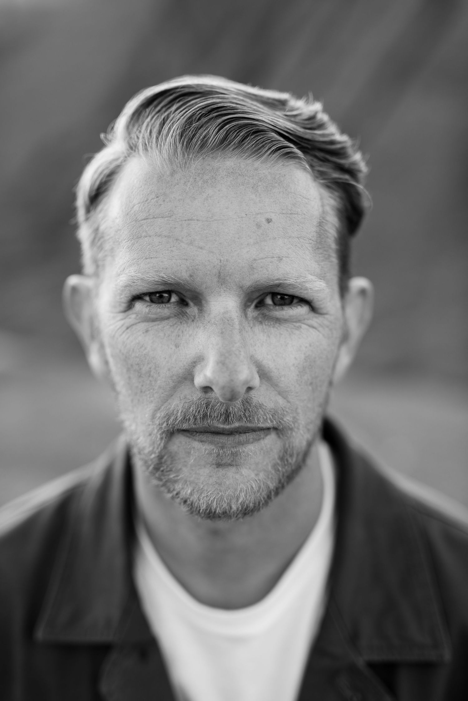 Black and white portrait series showing various angles of a person's facial features.