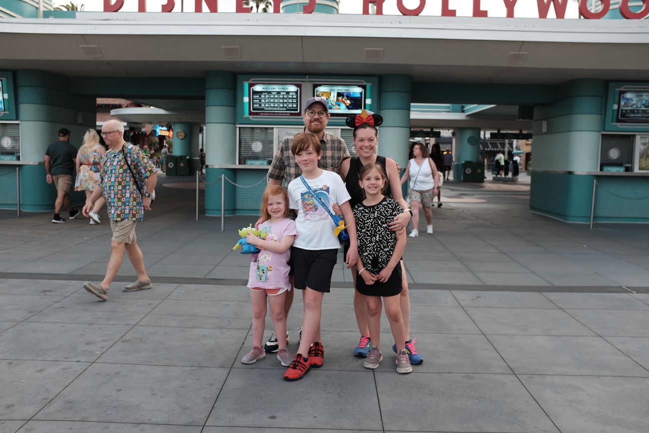 Group photo in front of Disney's Hollywood Studios entrance sign.