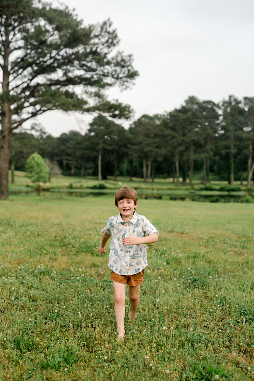 little boy running in field birmingham alabama
