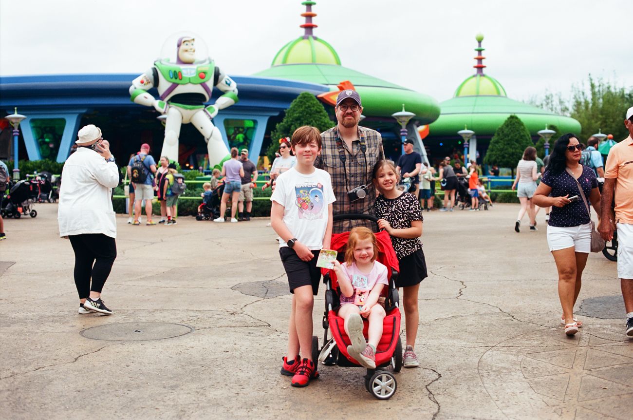 Toy Story themed area at Disney World with large Buzz Lightyear figure and green domed structures.