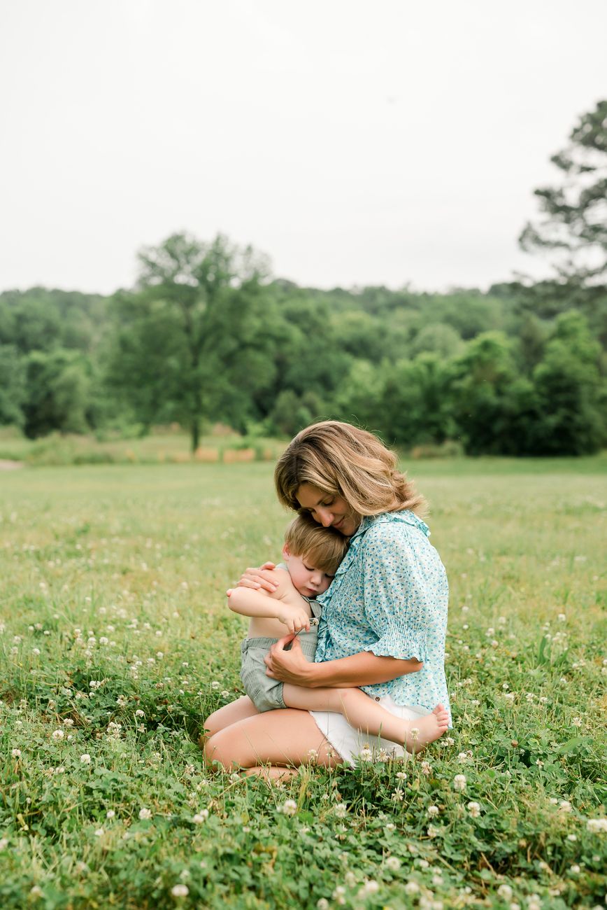 mother and baby in grassy field hugging birmingham al
