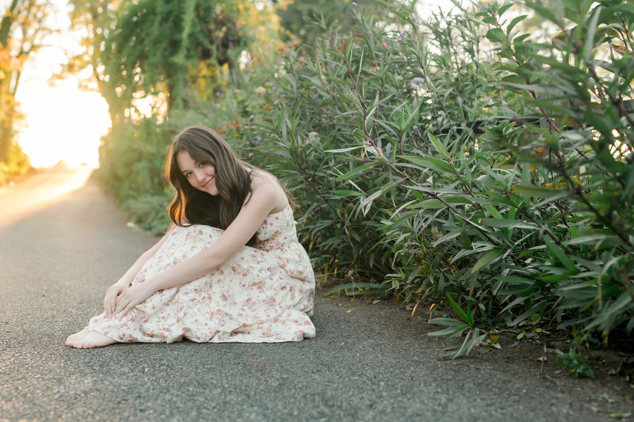 Golden sunset light illuminates a garden setting with natural foliage and outdoor portraits.