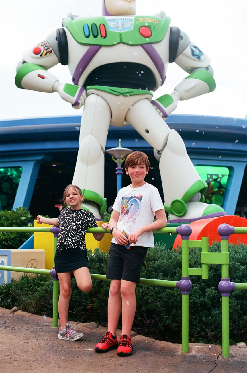Giant Buzz Lightyear statue towering over visitors in Toy Story Land at Disney World.