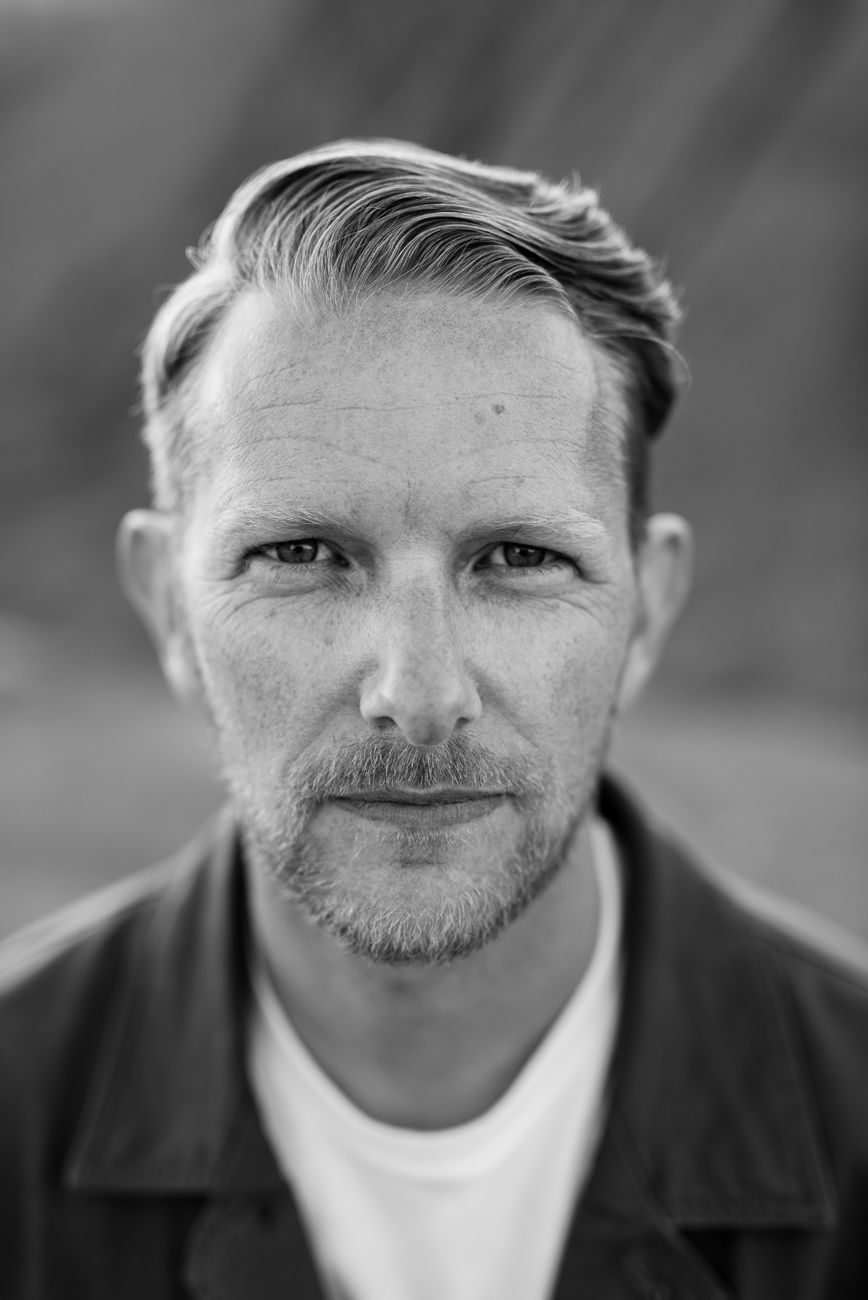 Black and white portrait shot with dramatic lighting.