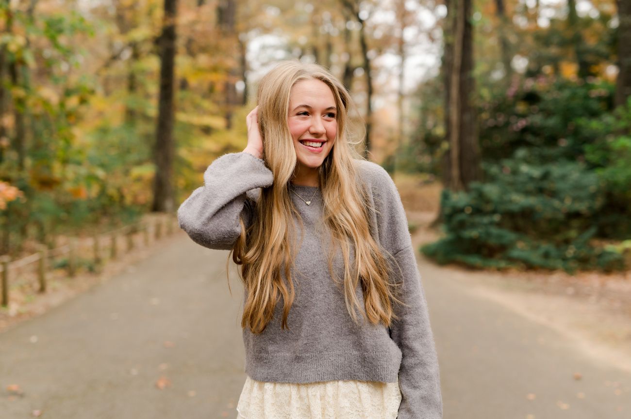 Candid outdoor portraits with joyful expressions and autumn foliage in background.