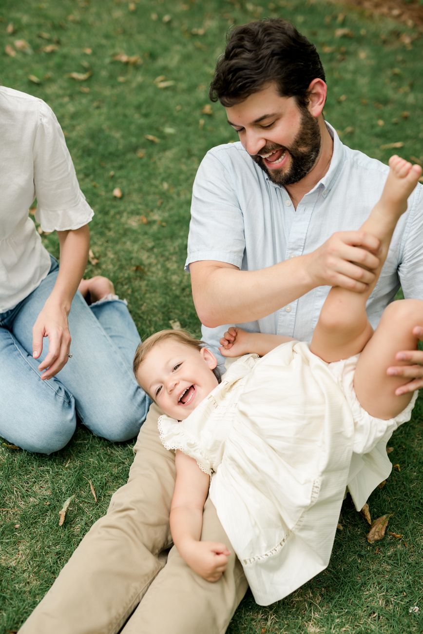 A playful sequence of candid moments captured on green grass during a sunny day.