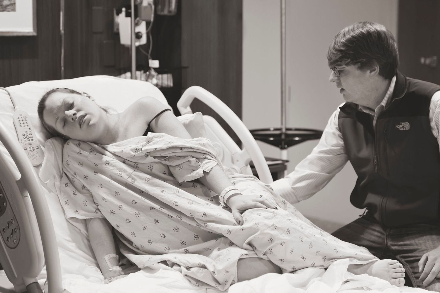 A laboring patient receives care and monitoring in a hospital delivery room.