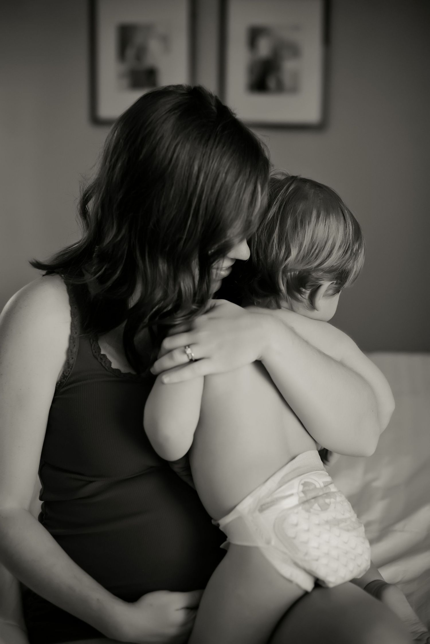 An intimate black and white photo captures a tender moment between parent and child.