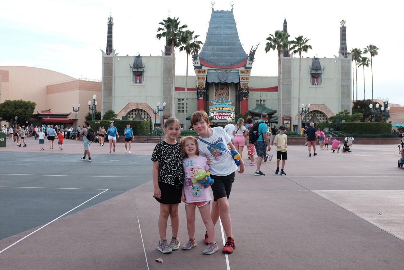 Visitors posing in front of the Chinese Theater facade at Disney's Hollywood Studios.