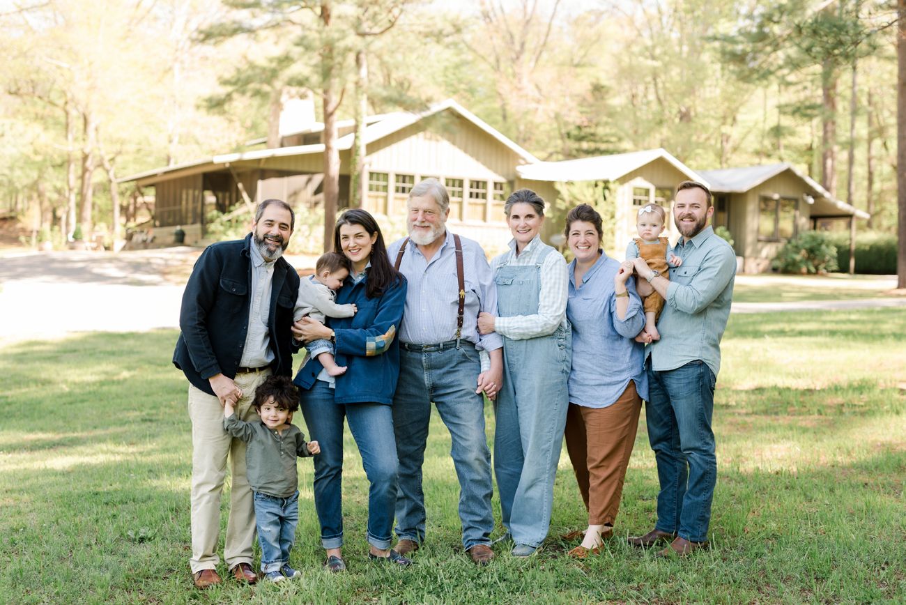 Extended family group photo in casual attire standing together outdoors.