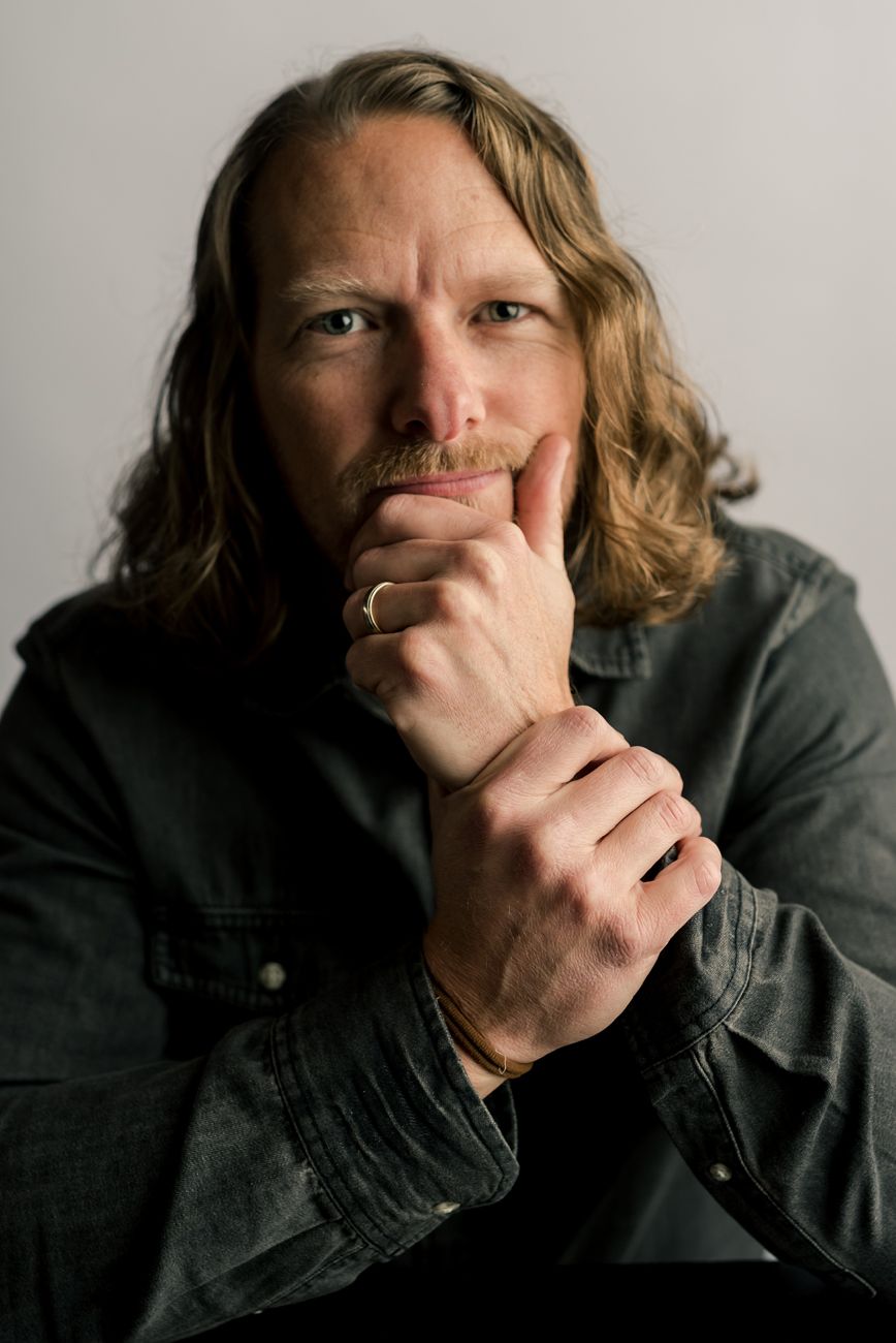 Artistic portrait series in moody lighting showing contemplative poses.