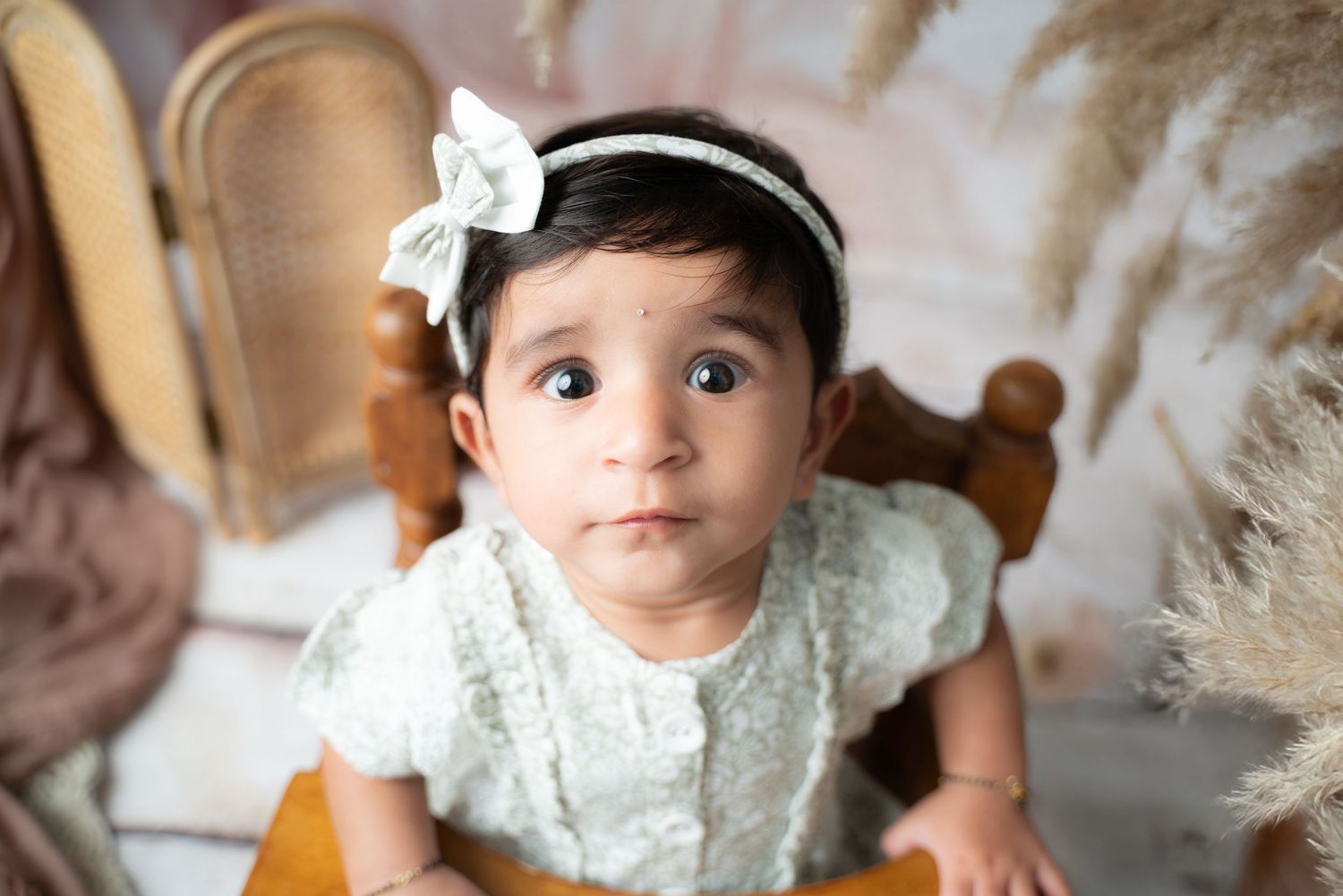 Teddy bear themed baby photography setup with soft lighting and neutral tones.