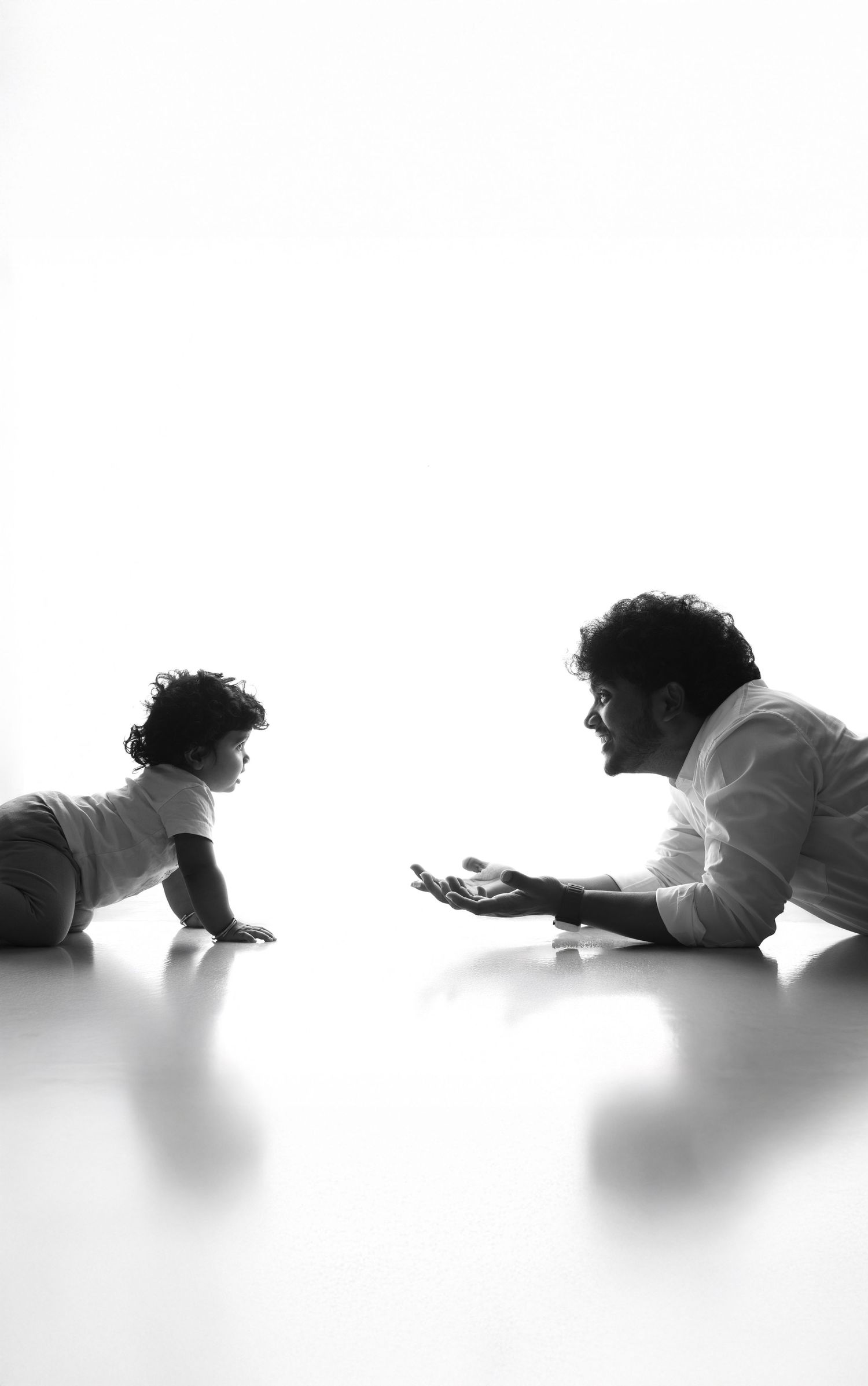 Minimalist black and white baby photography showing crawling progression sequence.