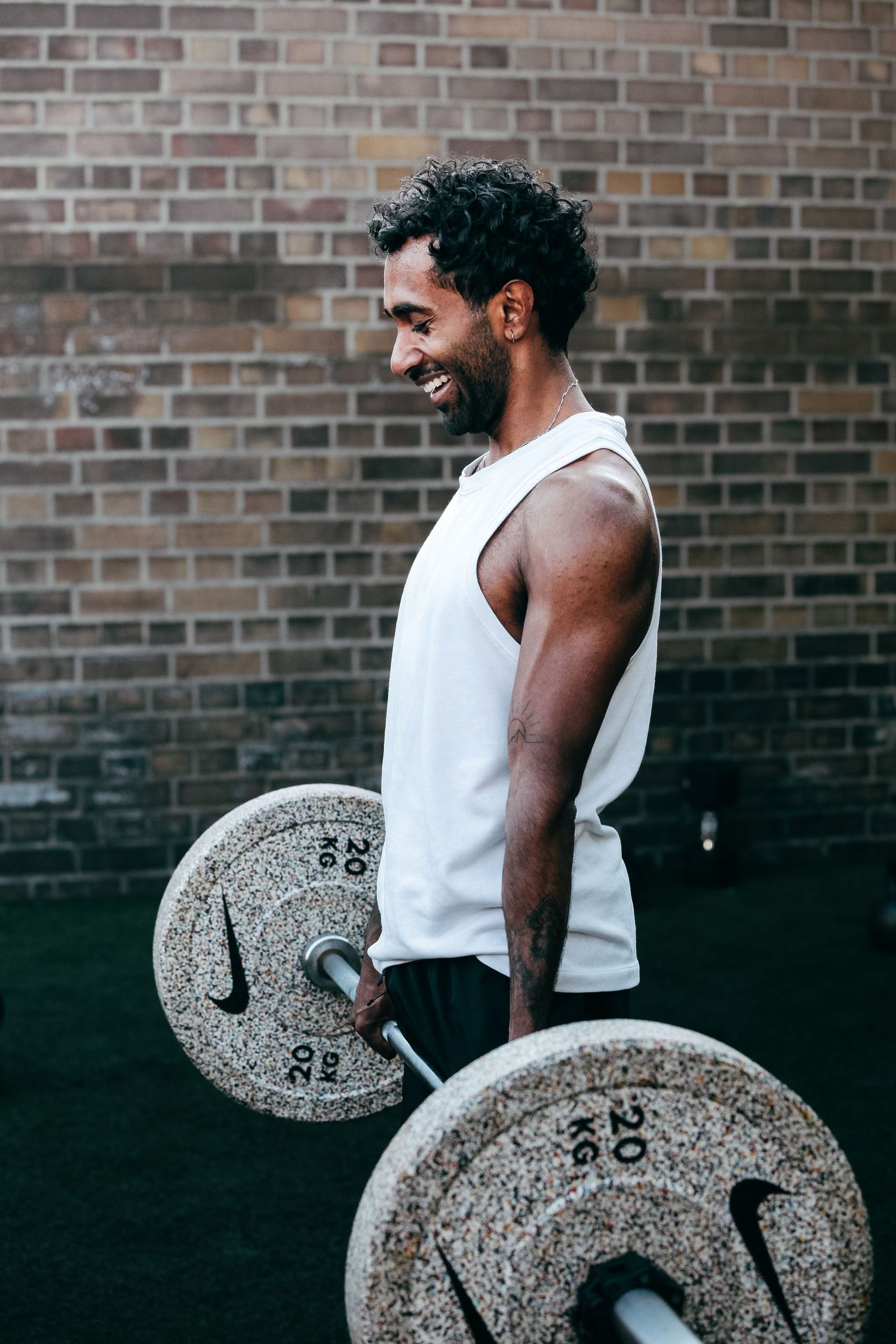 someone smiling doing a deadlift