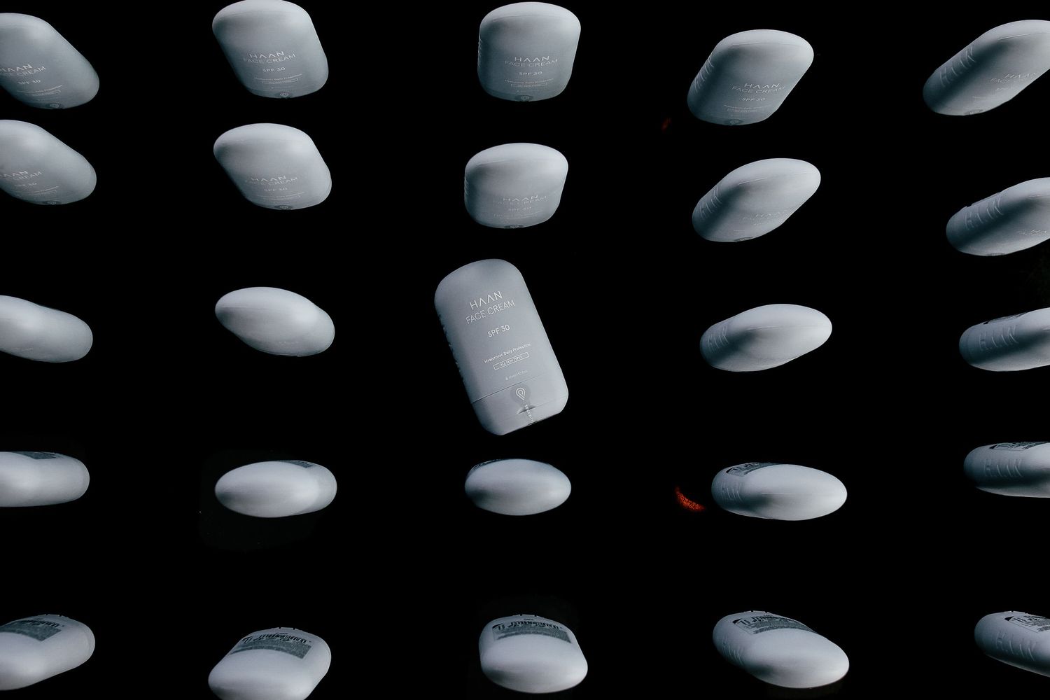 Abstract pattern of white circular lights against dark background creating geometric design.