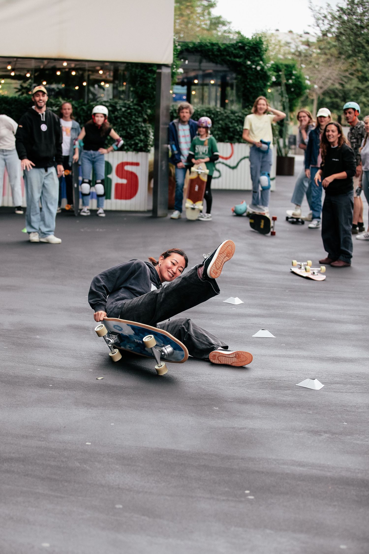 Sequence of a skateboarder falling while attempting a trick on concrete ground.