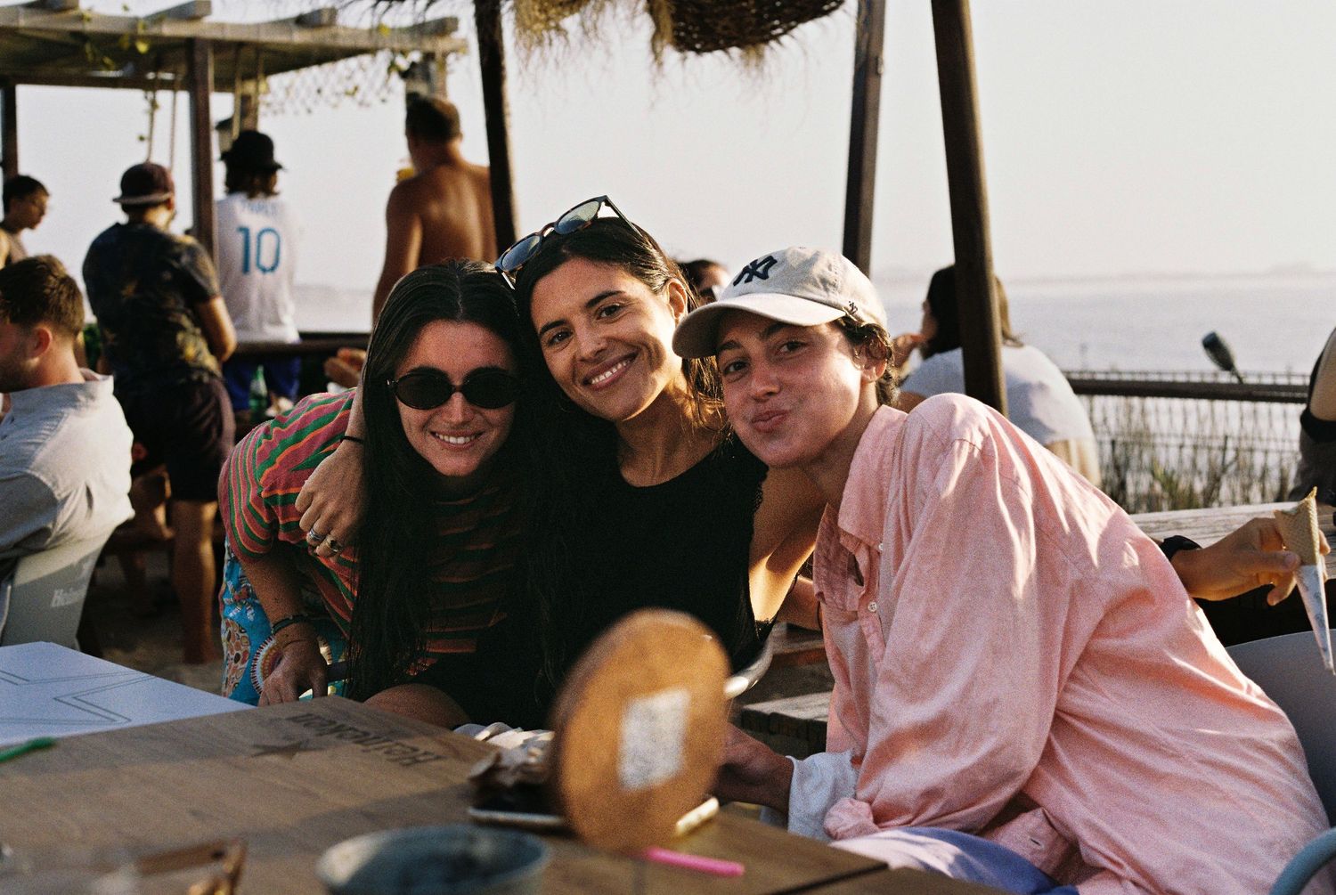 Friends relaxing at an outdoor beachside restaurant.