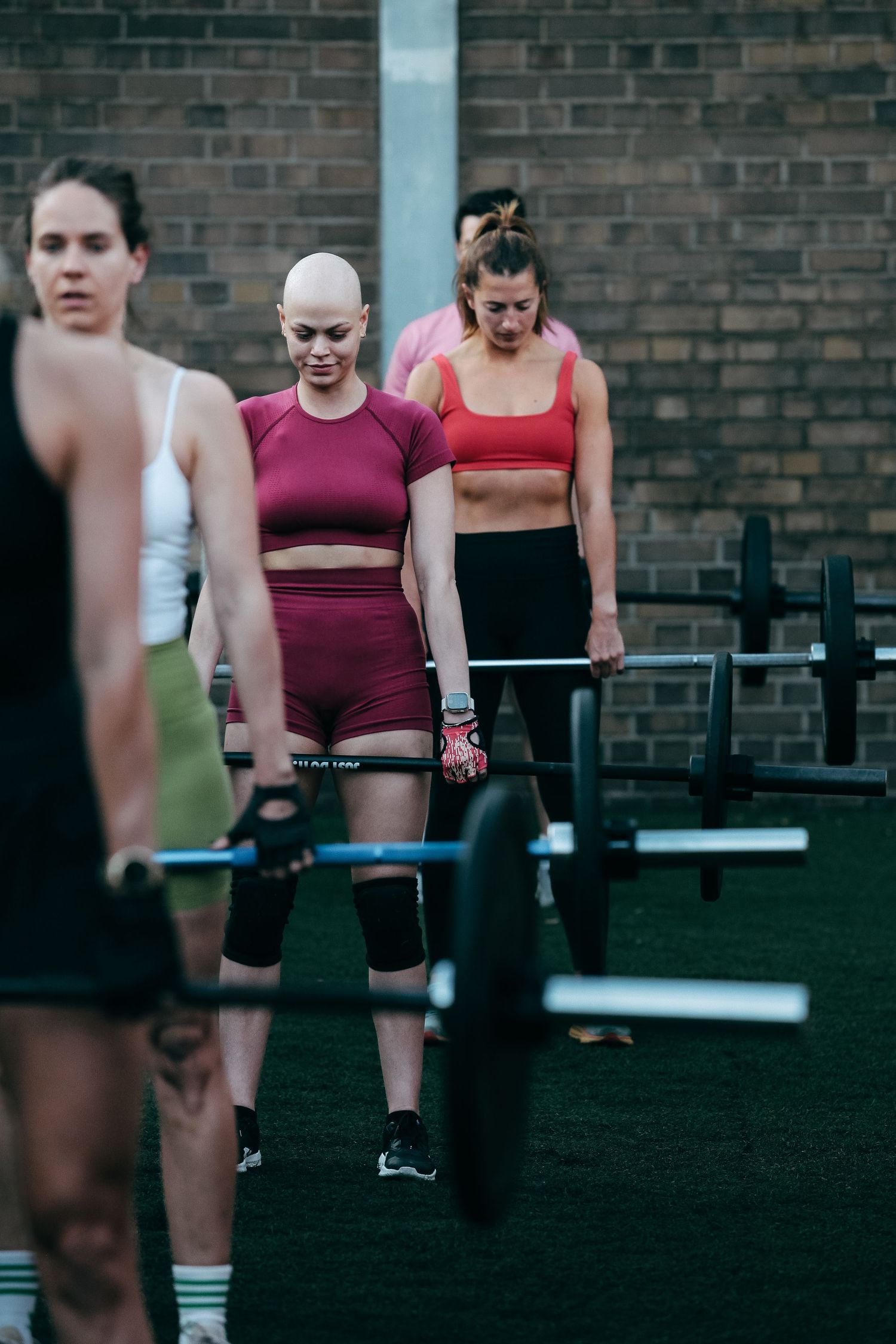 Group fitness class doing deadlift